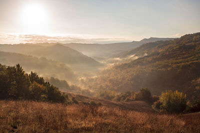 Scenic view of landscape and mountains against sky