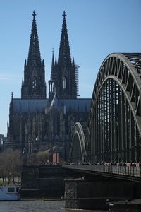 View of arch bridge over river against buildings