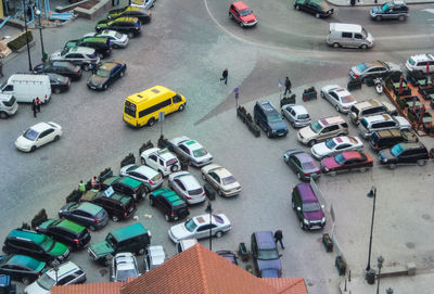 High angle view of people and cars on street in city