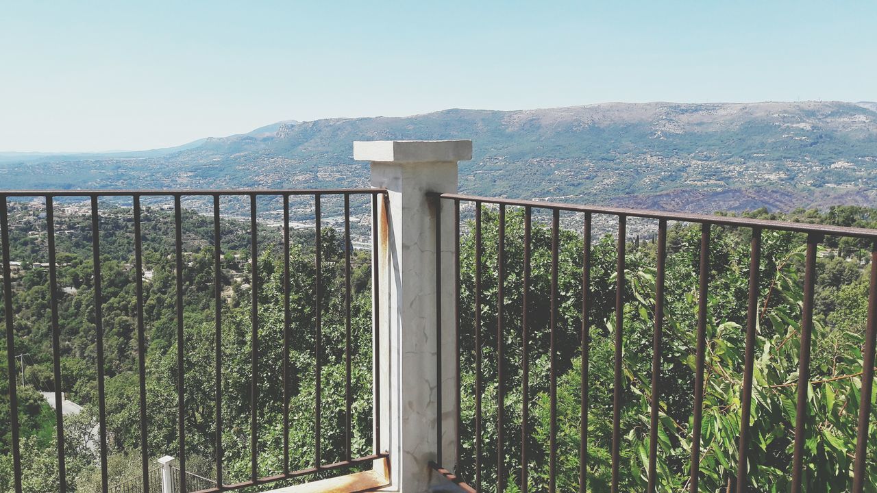 mountain, mountain range, nature, scenics, beauty in nature, day, tranquil scene, tranquility, railing, no people, landscape, clear sky, outdoors, sky, plant, growth, water