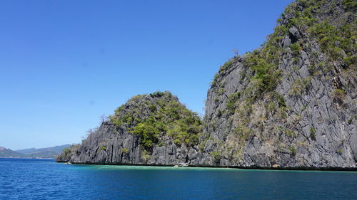 Scenic view of sea against clear blue sky