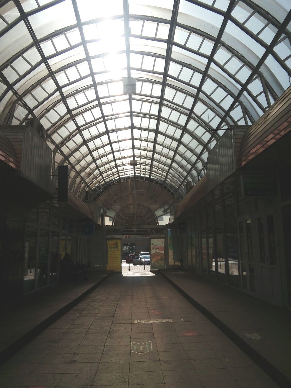 indoors, ceiling, incidental people, architecture, railroad station, built structure, arch, day, railroad station platform, skylight, glass, interior, modern, arcade, pedestrian walkway