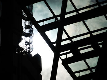 Low angle view of cloudy sky seen through glass ceiling