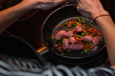 Cropped hand of person preparing food