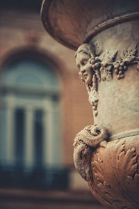 Close-up of old statue against blurred background