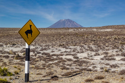 Road sign against sky