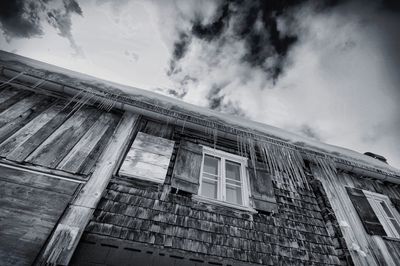 Low angle view of building against cloudy sky