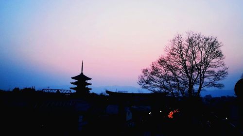 Silhouette trees against sky at sunset