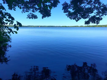 Scenic view of lake against blue sky