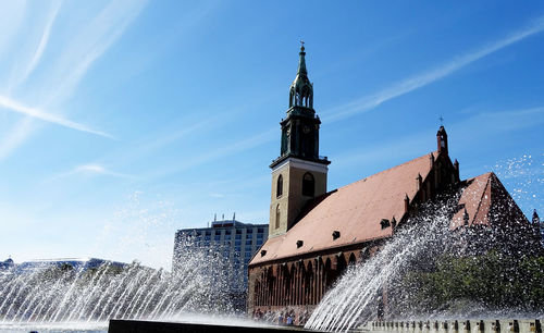 Fountains by st mary church against sky