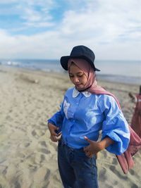 Young woman standing on beach