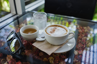 Close-up of cup and coffee on table