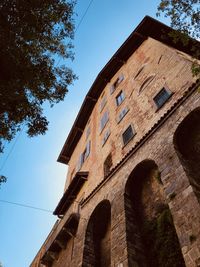 Low angle view of old building against clear blue sky