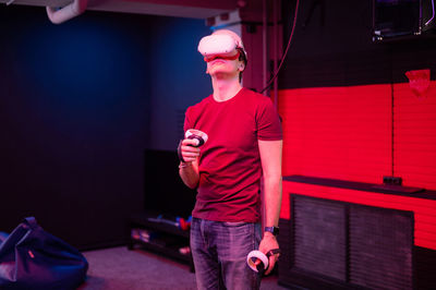 Vr game and virtual reality. man gamer fun playing on futuristic simulation video shooting game