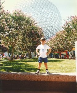 Full length of man playing with ball in background