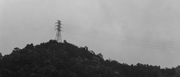 Low angle view of electricity pylon against sky