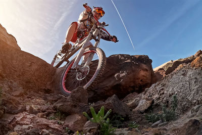 Low angle view of man standing on rock