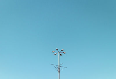 Low angle view of street light against clear blue sky