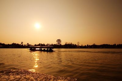 Scenic view of river against clear sky during sunset