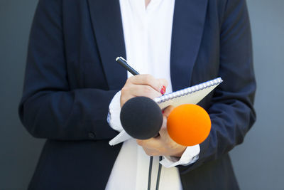 Midsection of man holding umbrella