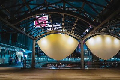 Low angle view of illuminated railroad station at night