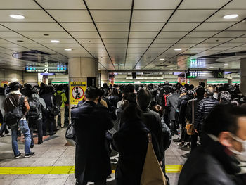 People walking on railroad station platform