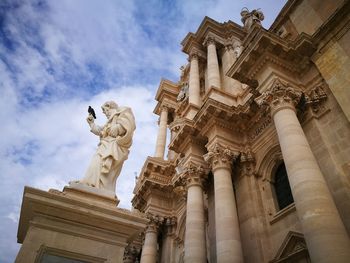 Low angle view of statue against sky