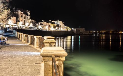 Illuminated city at waterfront