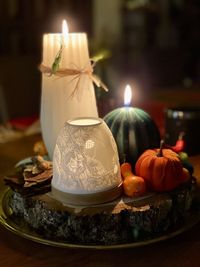 Close-up of illuminated candles on table