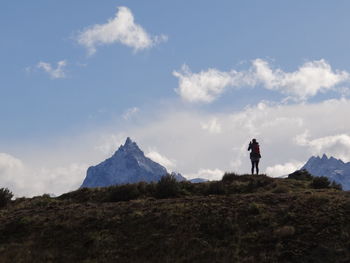 Man standing on mountain against sky