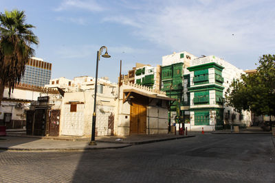 Street amidst buildings in city against sky