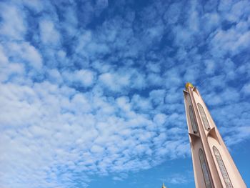 Low angle view of crane against sky