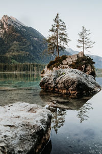 Rocks in lake against sky