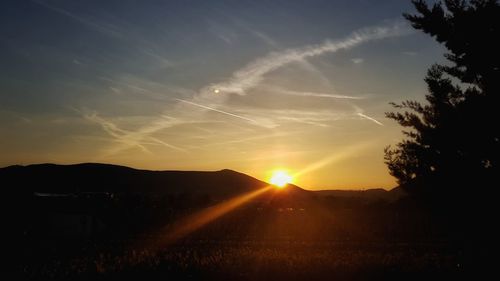 Silhouette landscape against sky during sunset