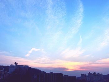 Silhouette buildings against sky during sunset