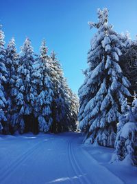 Scenic view of snow covered landscape against clear sky