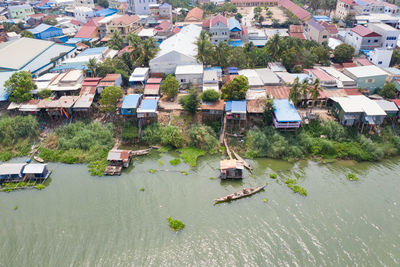 High angle view of houses by river and buildings