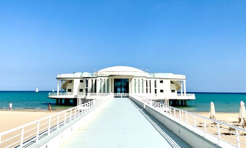 View of sea against clear blue sky