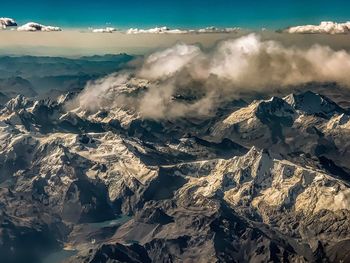 Aerial view of snowcapped mountains against sky