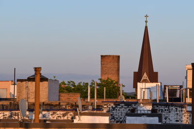 Buildings in city against clear sky