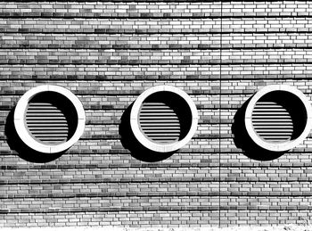 Close-up of electric lamp on brick wall