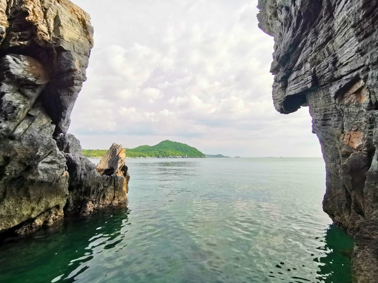 SCENIC VIEW OF SEA AGAINST ROCK FORMATION