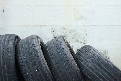 Close-up of tires against wall