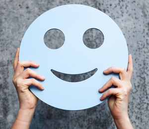 Close-up of human hand holding smiley