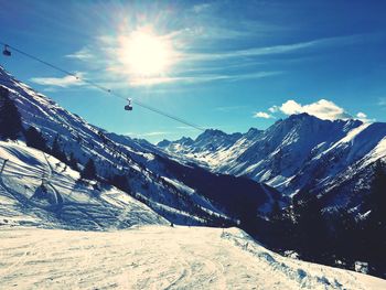 Scenic view of snow covered mountains against sky