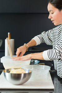 Young woman preparing food at home