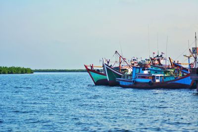 Boat sailing in sea against sky