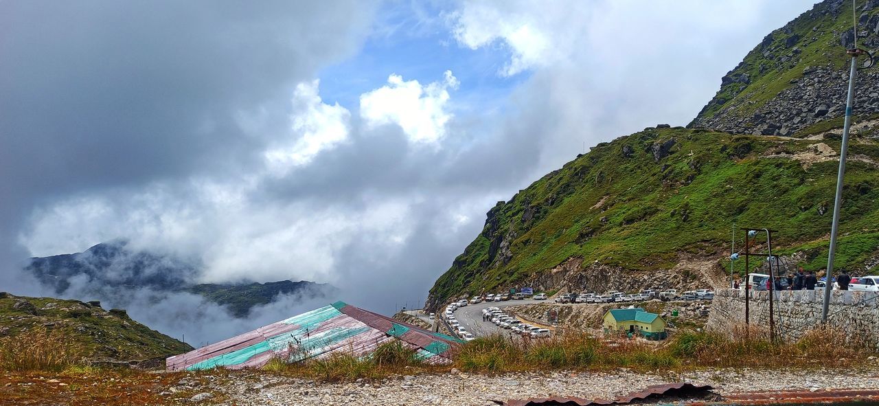 cloud, mountain, sky, environment, nature, mountain range, scenics - nature, landscape, land, beauty in nature, sea, coast, water, travel, travel destinations, outdoors, no people, panoramic, architecture, activity, day, tourism, plant, non-urban scene