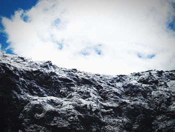 Scenic view of mountains against cloudy sky