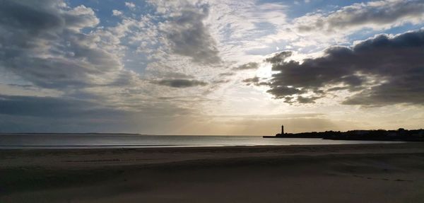 Scenic view of beach against sky during sunset
